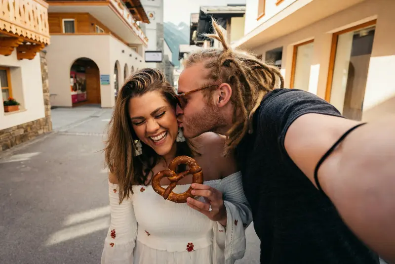 street couple holding pretzels