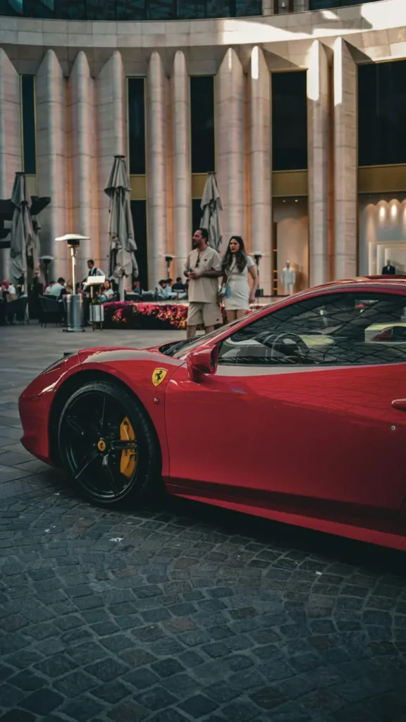 Red Ferrari parked on a luxury street in Abu Dhabi with modern skyline