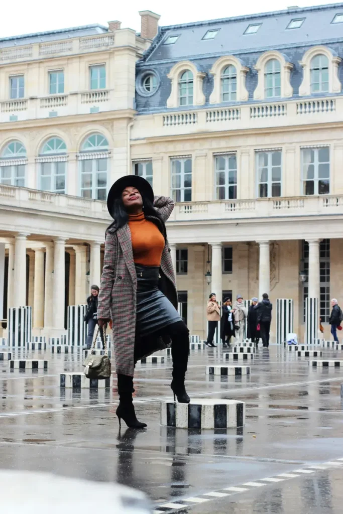 Red windmill of Moulin Rouge cabaret in Paris three girl taking picture